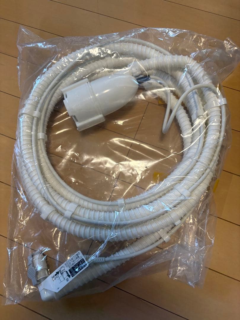 New, unused. Sharp ES-X11B accessory: wash water pump with hose.